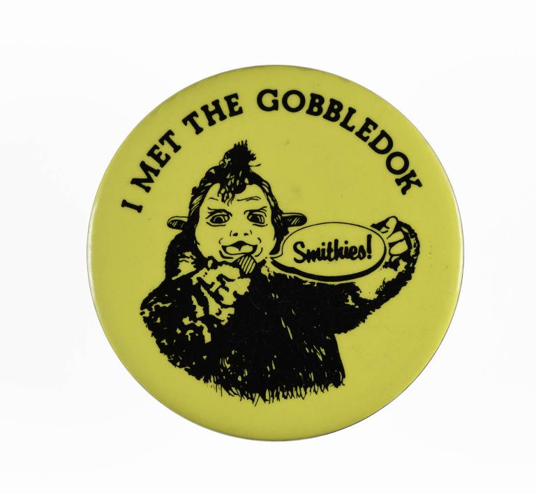 A photo of a circular yellow badge with the text "I met the gobbledok".