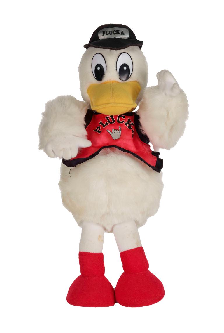 White duck plushie with orange feet, a black cap and a red top