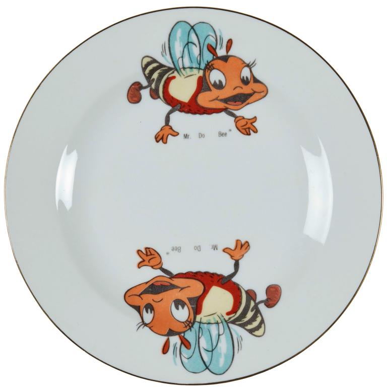 A white plate with two cartoon bees on either side