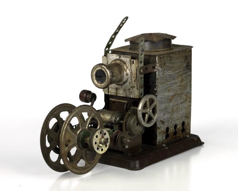 A photo of a toy projector that is faded copper in colour. 