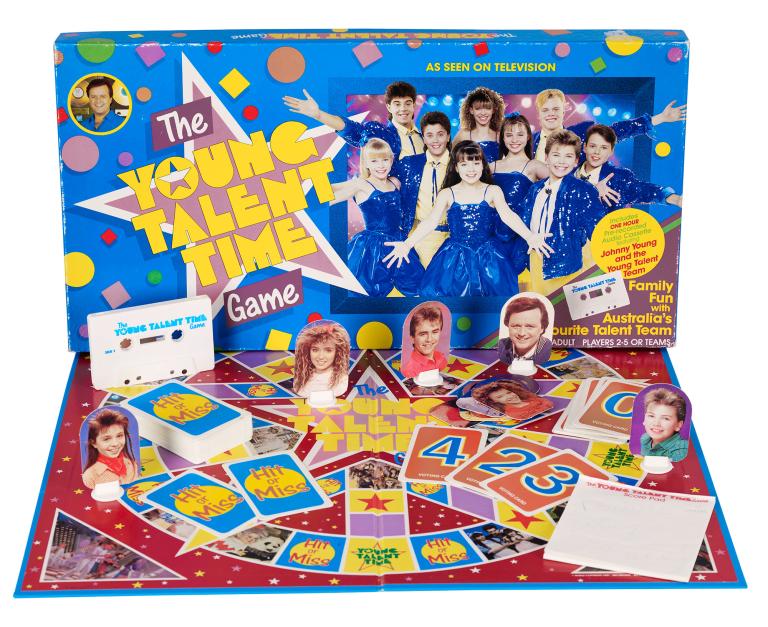 Bright blue and red boardgame featuring photos of the Young Talent Time cast