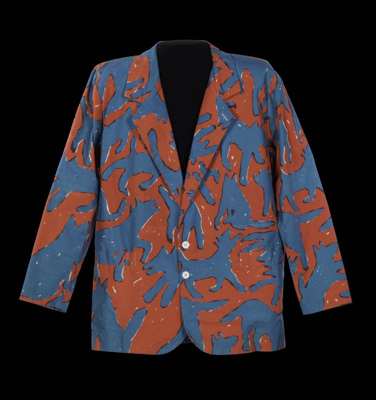 Colorful abstract patterned jacket designed in 1988 featuring orange and blue shapes on display