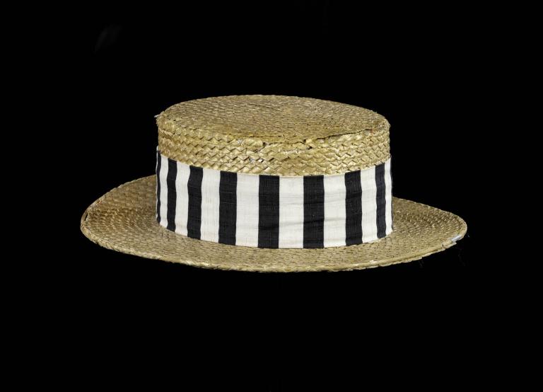 A photo of a straw boater hat with black and white stripes