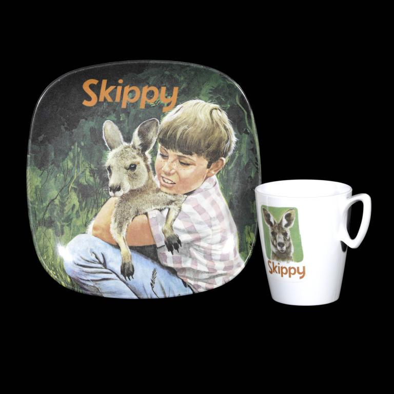 Vintage Skippy merchandise featuring a plate and mug with a boy cuddling a kangaroo, iconic Australian television series