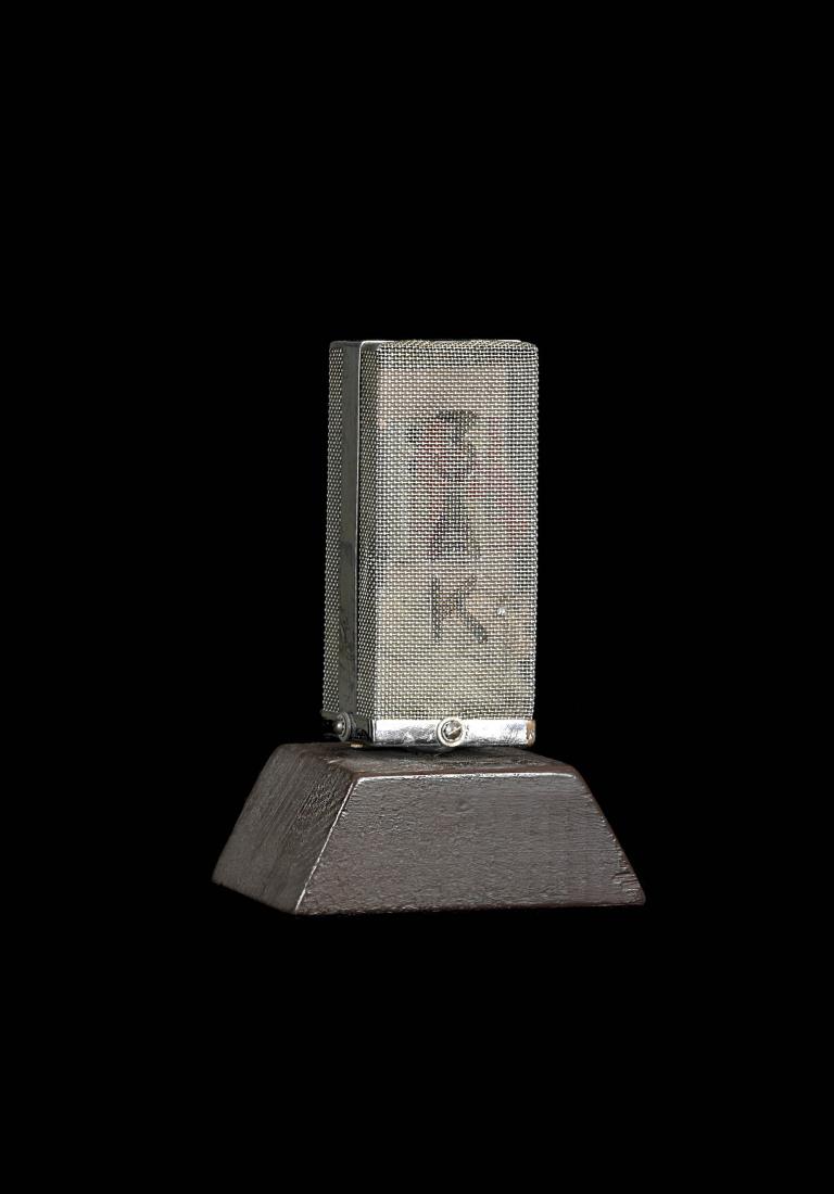 Vintage 3AK studio microphone with mesh cover on a wooden base