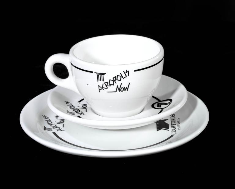 White cup and saucer set from Australian TV show 'Acropolis Now' with logo design