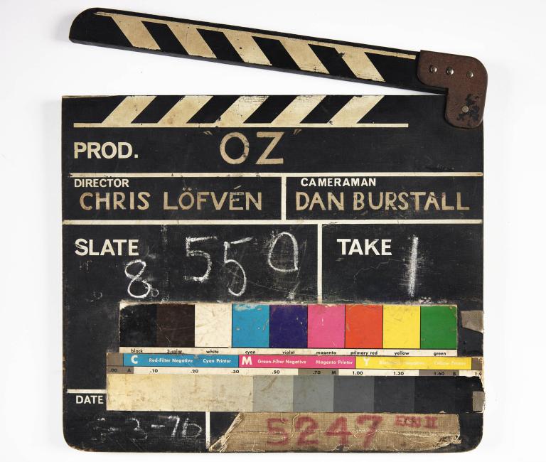Vintage clapperboard from the 1976 film 'Oz,' directed by Chris Löfven, showing slate 8 and take 1