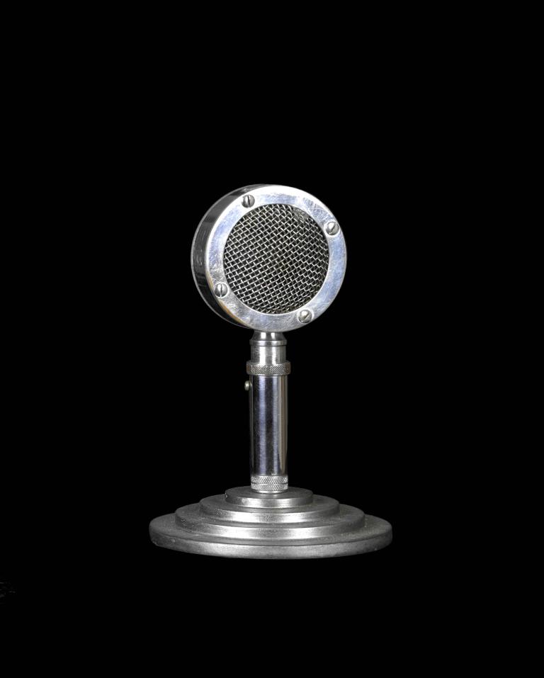  Astatic crystal microphone on a stand against a black background
