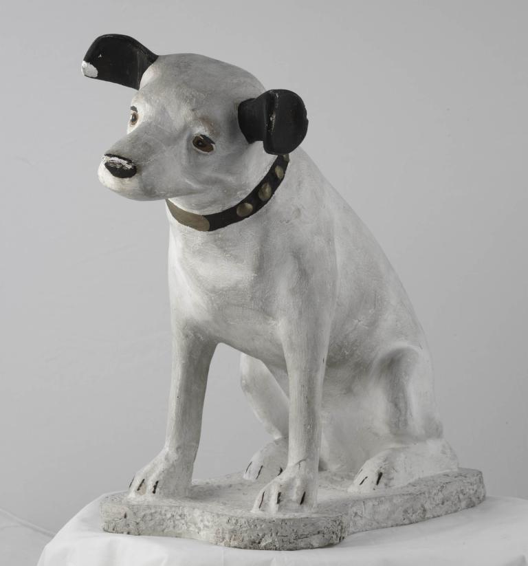 Sculpture of a seated dog named Nipper with black ears and a collar, known from the 'His Master's Voice' logo