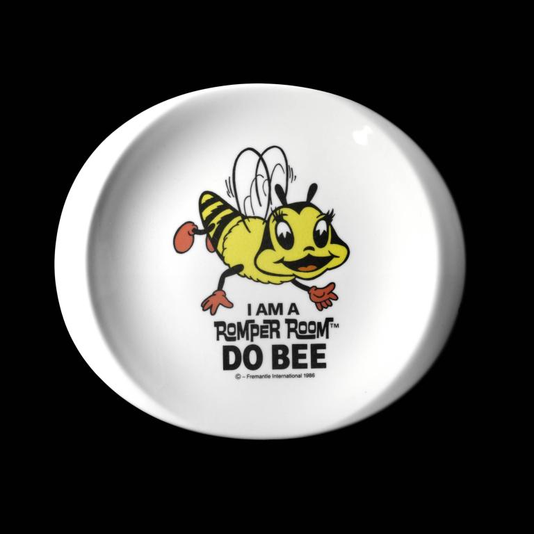 Colorful cartoon bee character with text from Romper Room 1986 on white plate