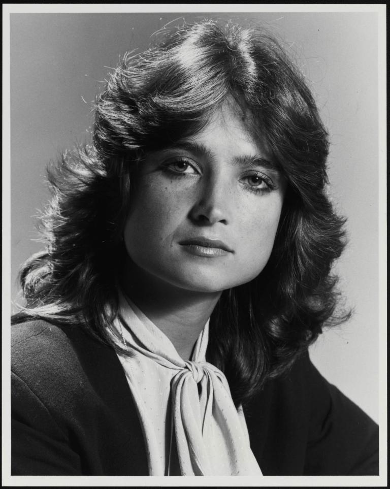 Black and white portrait of Jana Wendt with layered hair and a bow tie blouse from 1985