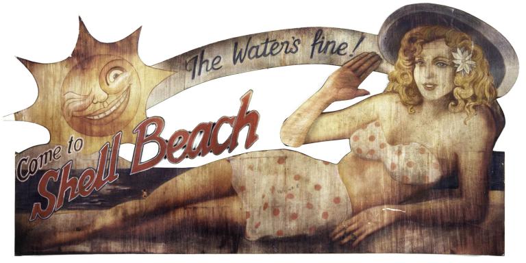 Miniature prop sign from Dark City with vintage sun, woman in bikini waving, and text: “The water’s fine! Come to Shell Beach