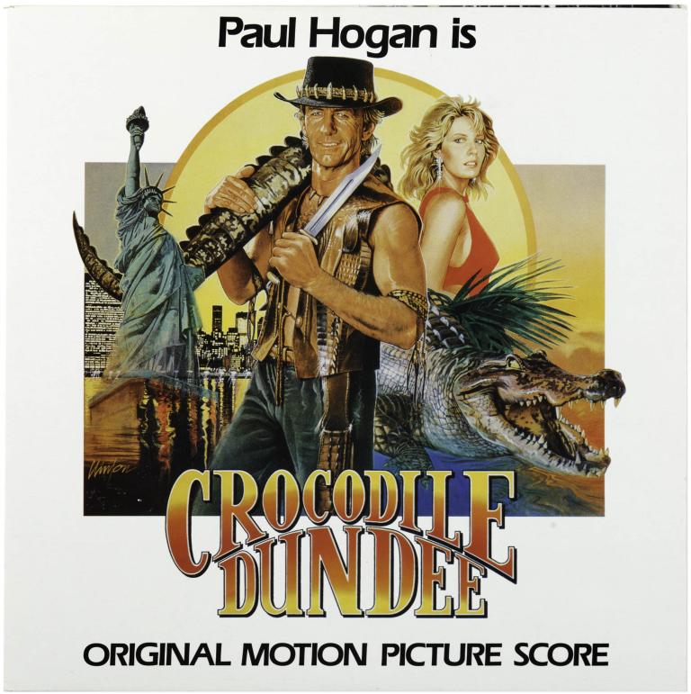 Vinyl record of Crocodile Dundee score by Peter Best, cover shows Paul Hogan as Mick Dundee in outback with rifle and crocodile