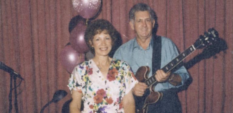 Album cover for Christmas Wishes from Lindsay and Joan. Features Joan and Lindsay posing for the camera; he is holidng a guitar.