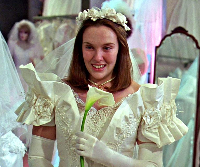 Muriel (Toni Collette) tries on a wedding dress in a bridal store.