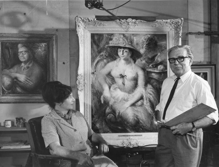Painter William Dobell standing next to his portrait of Margaret Olley with a woman seated.