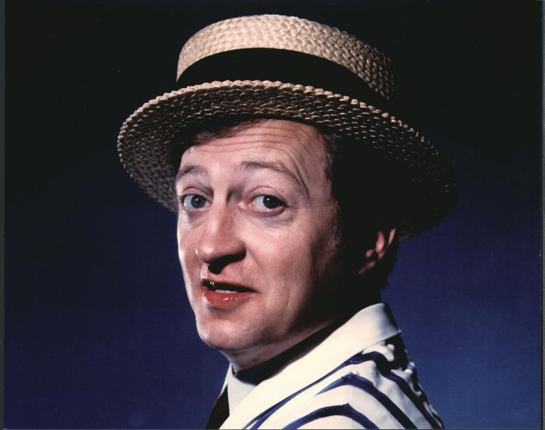Graham Kennedy in striped coat and straw boater hat