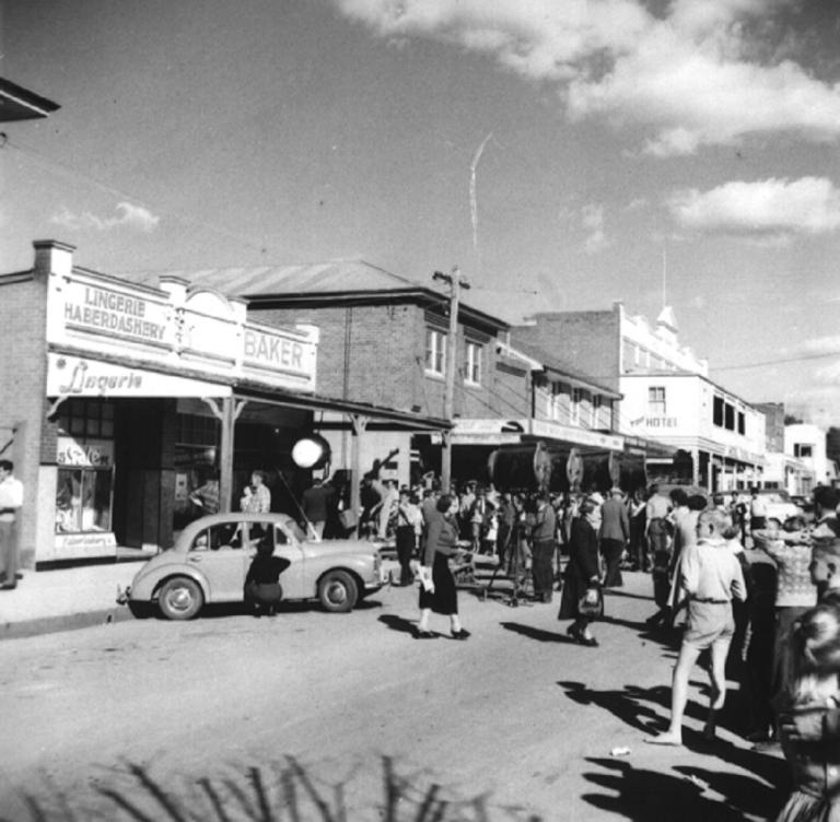 Candid street photo of production crew, equipment and onlookers during filming for The Shiralee