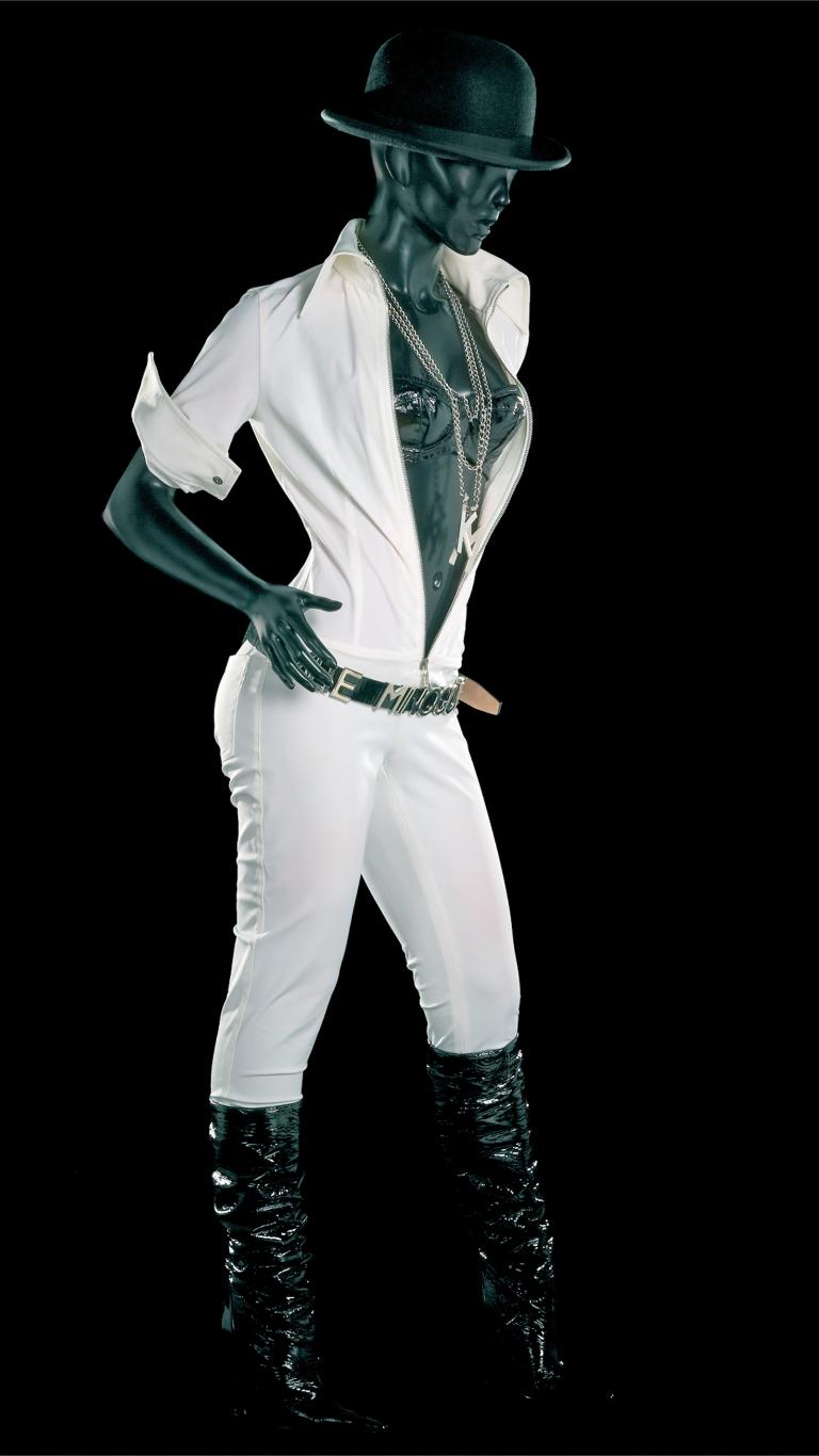 White jumpsuit, black boots, belt, hat and bra worn by Kylie Minogue in her Fever tour.