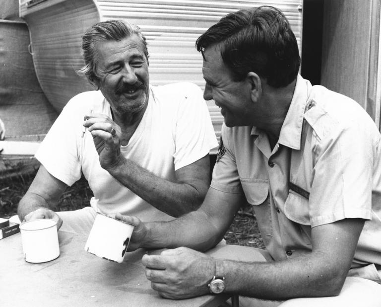 Chips Rafferty and Ed Devereaux taking a break with a cup of tea.