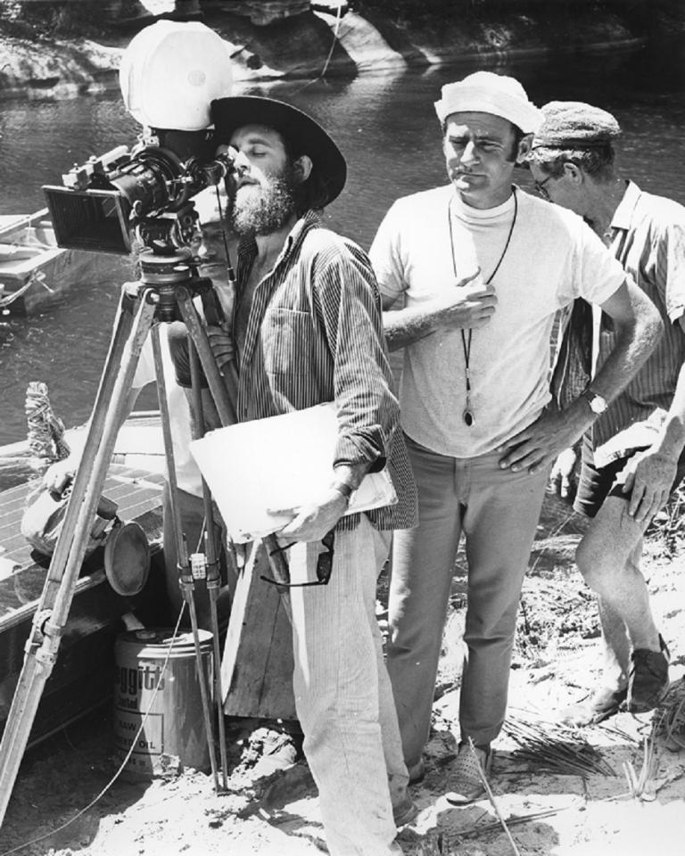 Skippy crew setting up a shot by a river.