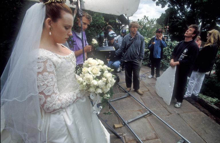 Toni Collette (as Muriel in wedding dress) with crew in the background