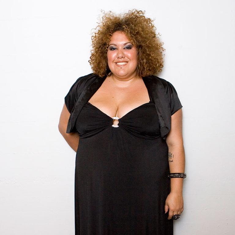 Casey Donovan smiling to camera in black dress