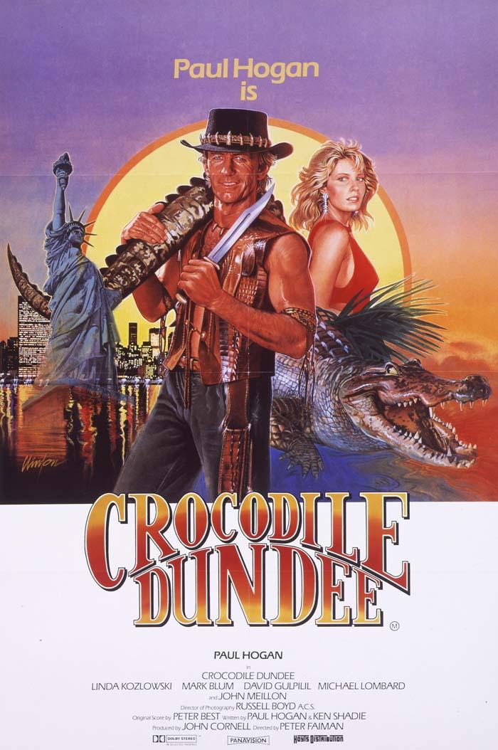 Australian poster for Crocodile Dundee showing illustrations of Mick Dundee, Sue Charlton and a crocodile with the outback and the New York City skyline as backgrounds