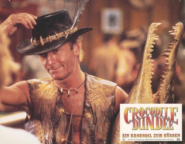 Mick and his buddy Lobby card showing Paul Hogan as Mick 'Crocodile' Dundee holding a taxidermied crocodile