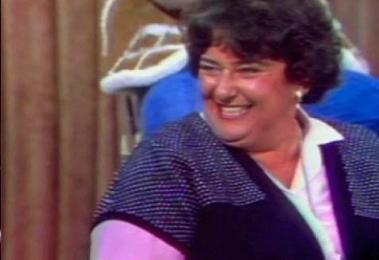 A female Number 96 cast member laughing while being interviewed on The Mike Walsh Show