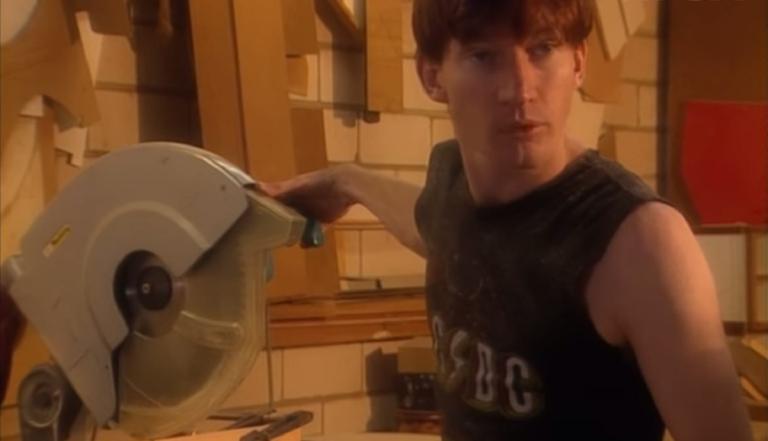 David Wenham, wearing a singlet, working in a kitchen manufacturing workshop