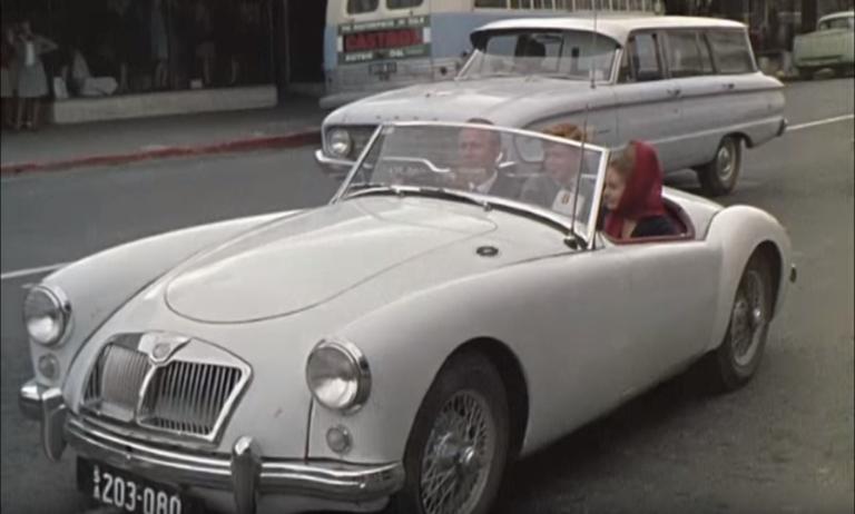 Three young people in a 1960s sports car, in Mount Gambier's main street