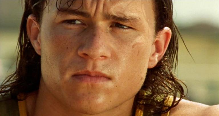 Heath Ledger as Jimmy in the film Two Hands. His face is in close-up and he looks sweaty and preoccupied. His long hair is wet.