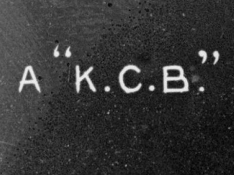 Cropped section of glass slide image that reads 'A "K.C.B".'