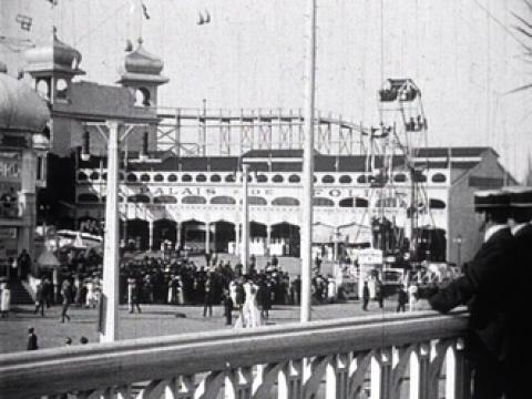 Luna Park in Melbourne. A rollercoaster at Luna Park in Melbourne. People are standing in the foreground in clothes that date it as early 1900s.