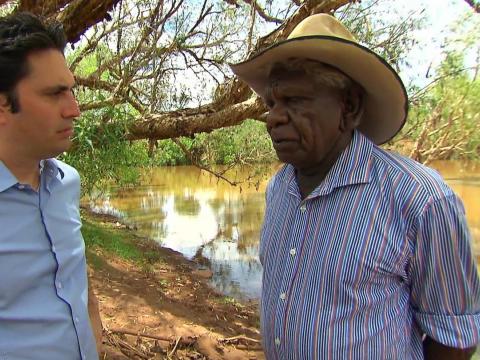Chris Taylor talks with Gurundji Elder Jimmy Wavehill on the shore of a bush lake