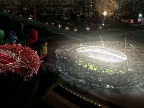 View of a sports stadium from above, lit up at night time.