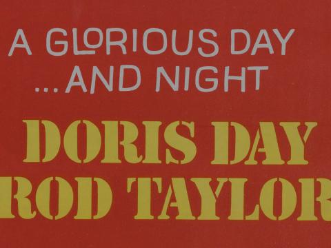 Section of a film poster that reads "A glorious day ... and night. Doris Day. Rod Taylor"