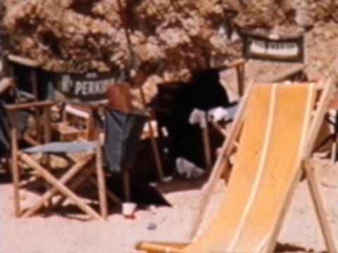 Beach chairs on the sand on the set of a film.