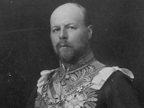 Head and shoulders image from the early 1900s of a man with a goatee dressed in a military uniform.