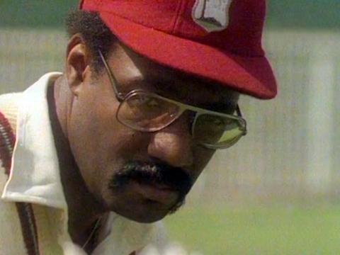 Close up of West Indian cricketer Clive Lloyd wearing a red cricket cap.
