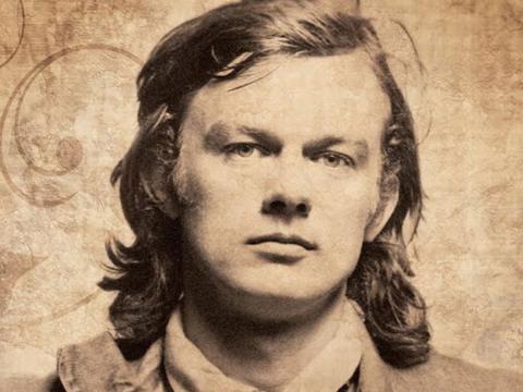 Head and shoulders shot of musician Broderick Smith looking directly at camera