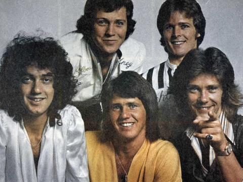 Five members of the band Sherbet, smiling and posing for a publicity photo, c1970s.
