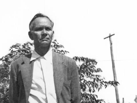 Jimmie Barker standing outside in front of a tree and telegraph pole