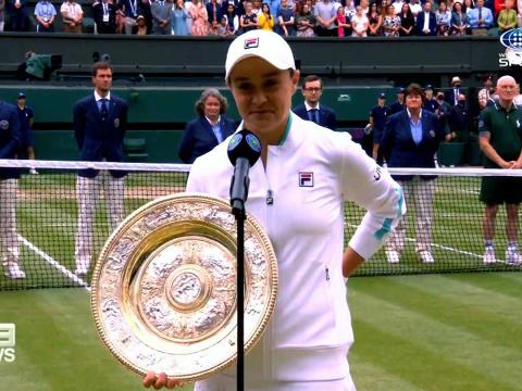 Tennis player Ash Barty holding the Wimbledon trophy, 2021