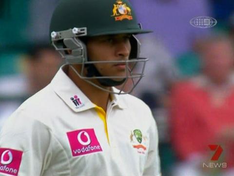 Head and shoulders shot of Australian cricket player Usman Khawaja in a helmet and white uniform.