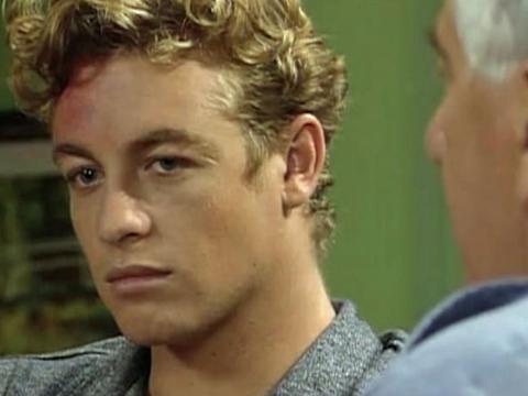 Simon Baker looking annoyed during a conversation in a scene from the soap opera E Street