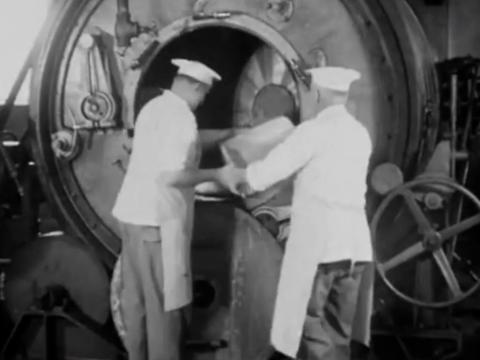 two men load butter into a machine