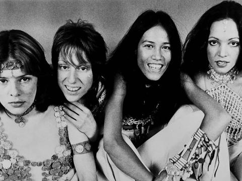 Four women look at the camera.