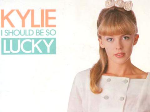 Kylie Minogue looks into the camera in a still on the sleeve of her 'I Should Be So Lucky' single.